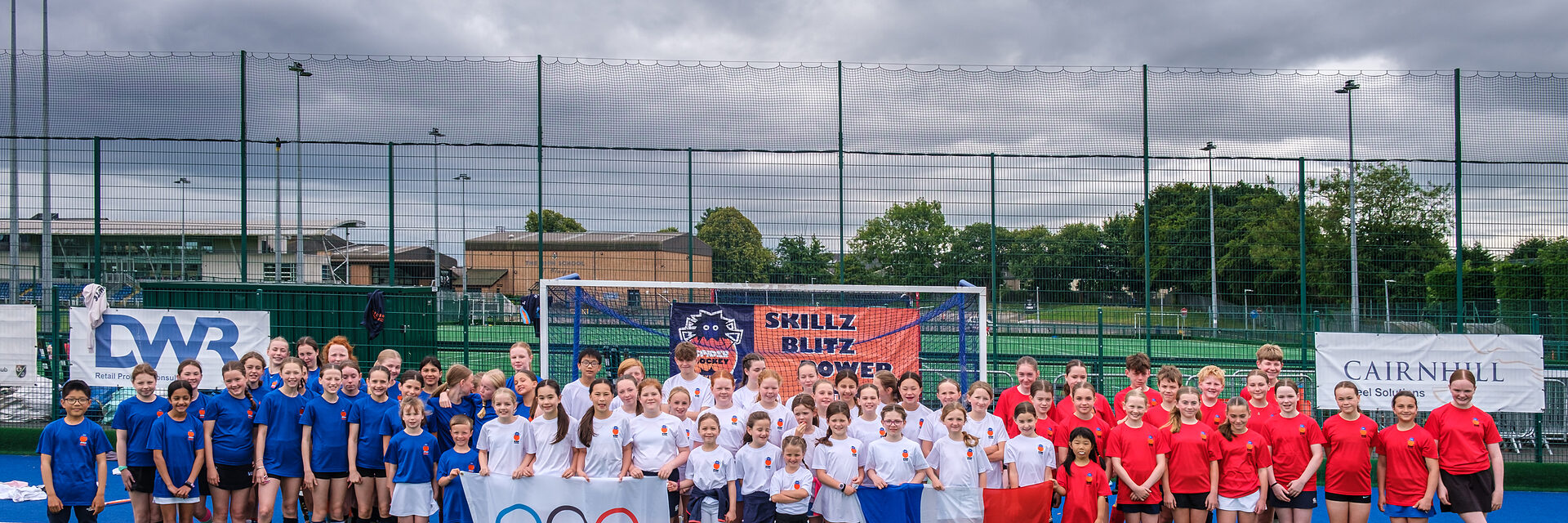 The full group of players and coaches together at a Spider Hockey tournament