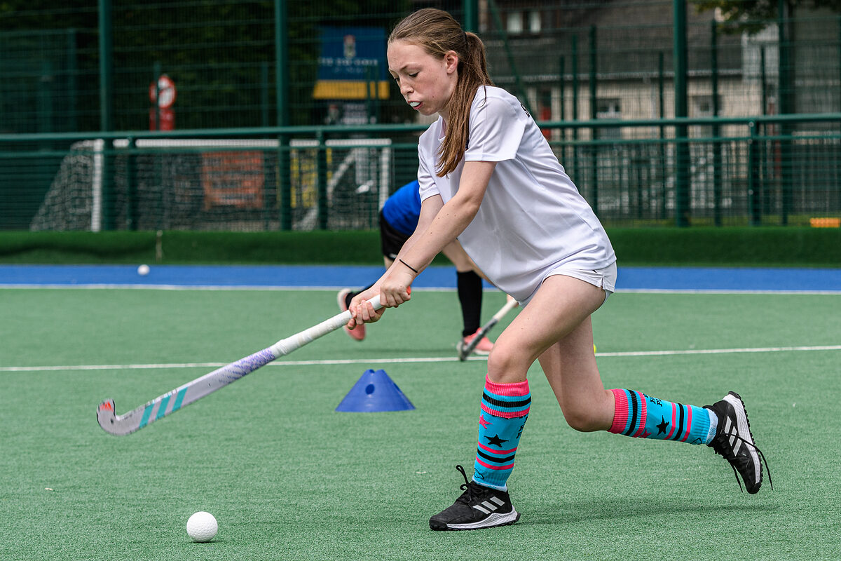 A young player demonstrating close stick control during a skills clinic