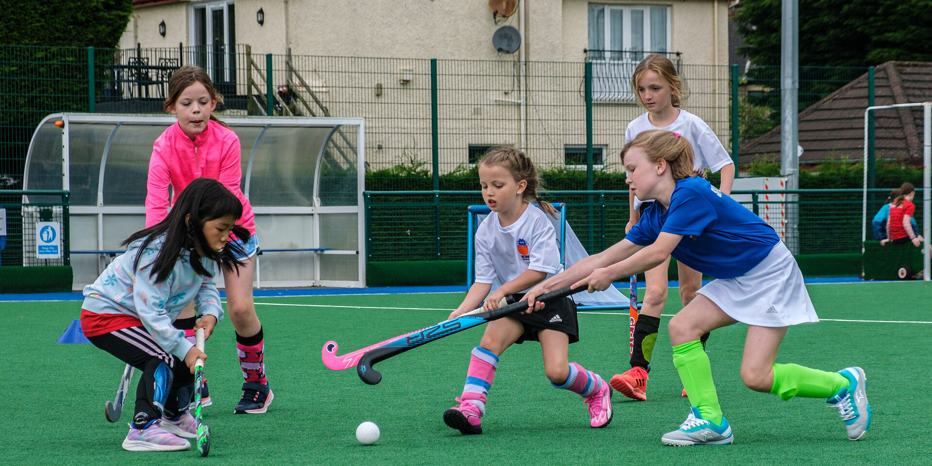 Spider Hockey Academy players competing for the ball during match play
